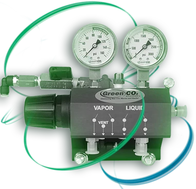 The Green CO2 Systems DS6000 differential diverter valve, a green block with two pressure gauges, vapor and liquid ports and a black hand wheel.